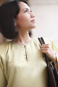 Portrait of young woman looking at camera