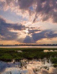 Scenic view of lake against sky during sunset