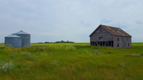 Barn on field against sky