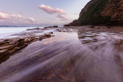 Scenic view of sea against cloudy sky