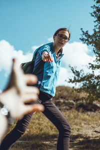 Cropped image of hand reaching to woman