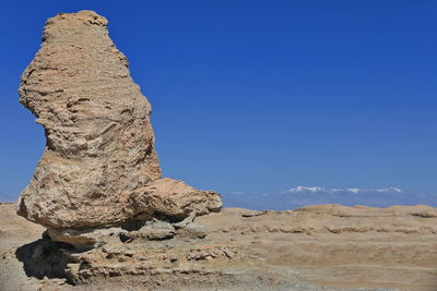 View of rock formation against clear blue sky