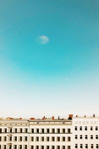 Low angle view of buildings against clear blue sky