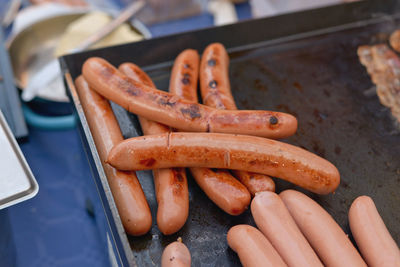 High angle view of grilled sausages on container