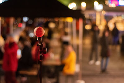 People playing on illuminated street at night