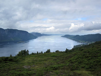 Scenic view of land and mountains against sky