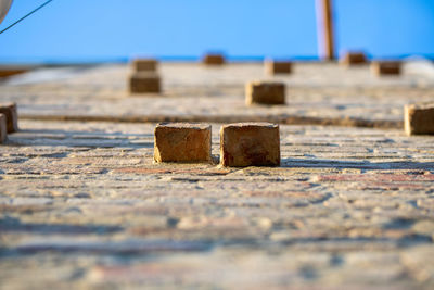 Surface level of wood against sky on sunny day