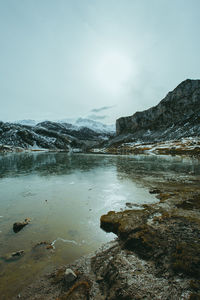 Scenic view of lake against sky during winter