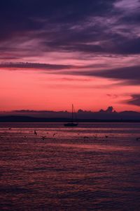 Scenic view of sea against orange sky