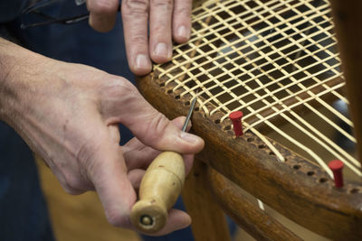 Cropped hand of person making chair