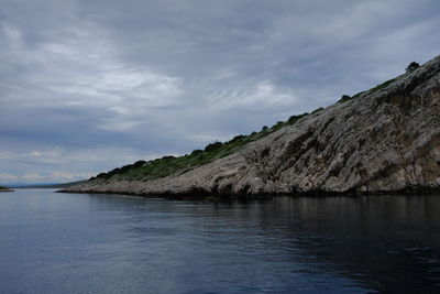 Scenic view of sea and mountains against sky