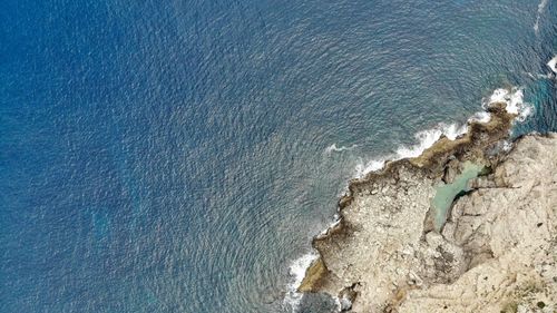 High angle view of rocks by sea