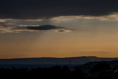 Scenic view of silhouette mountains against sky during sunset