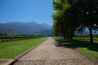 Empty country road leading towards mountains