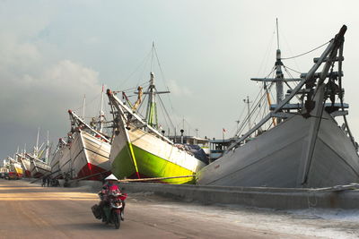 People on boat against sky