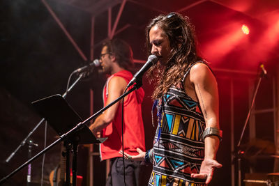 Man and woman singing song on stage