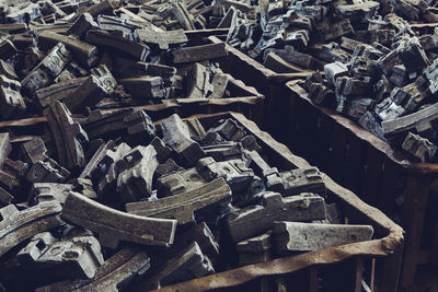 Full frame shot of old rubbers in containers at junkyard