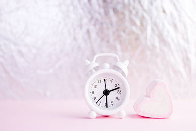 Close-up of clock on table at home