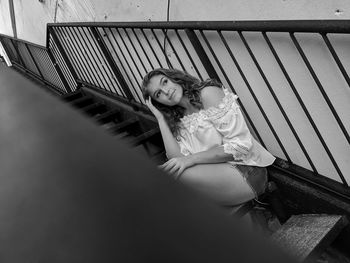 High angle portrait of woman sitting outdoors