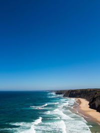 Scenic view of sea against clear blue sky