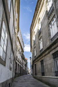Street amidst buildings against sky