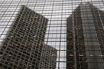 Low angle view of glass building against sky