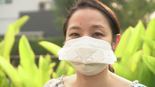 Asian woman wearing mask looking ill cough corona a allergy symptom