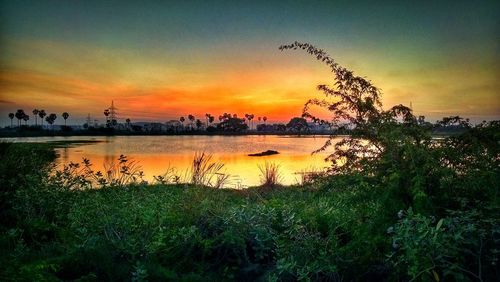 Scenic view of lake against sky during sunset