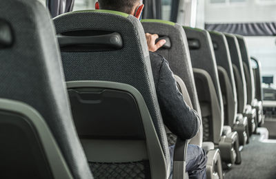 Rear view of man sitting in bus