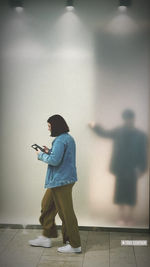 Side view of boy standing on wall