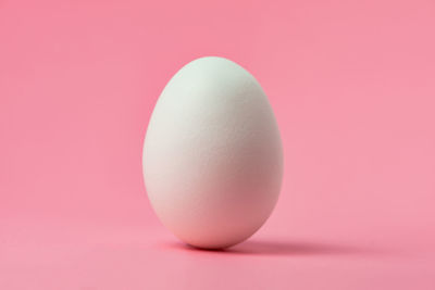 Close-up of apple against pink background