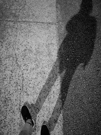 Low section of woman standing on tiled floor