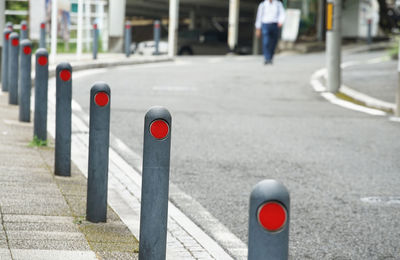 Pole separating the road from the sidewalk