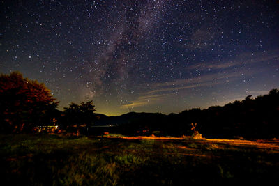 Scenic view of field against sky at night