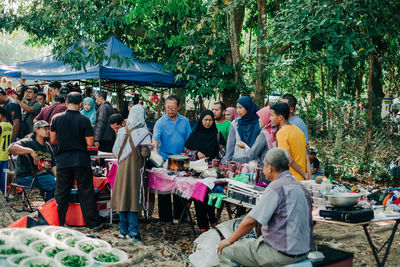 Group of people at market stall