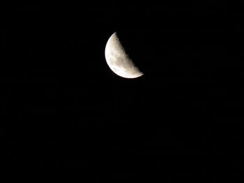 Low angle view of moon against clear sky at night