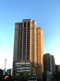 Low angle view of buildings against clear blue sky