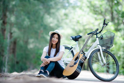 Young woman sitting on bicycle