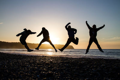 Silhouette of men on beach