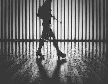 Side view of woman walking on tiled floor