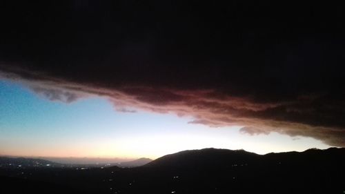 Scenic view of silhouette mountain against sky at sunset