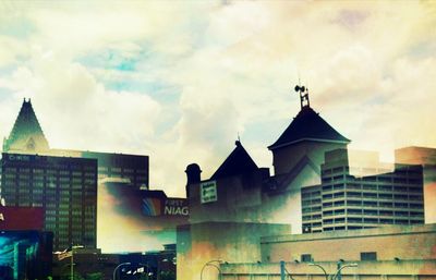 Low angle view of building against cloudy sky