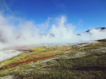 Scenic view of mountains against cloudy sky