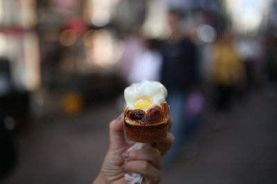 Close-up of hand holding ice cream cone