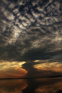 Scenic view of dramatic sky over sea during sunset