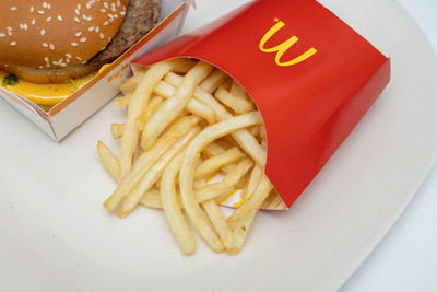 High angle view of burger and fries in plate on table