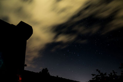 Low angle view of silhouette trees against sky at night