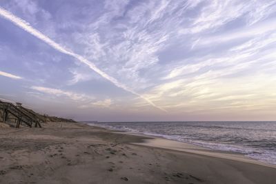 Scenic view of beach against sky during sunset