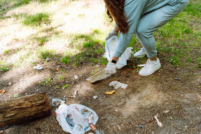 Low section of woman standing on field