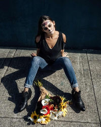 Portrait of smiling young woman sitting outdoors